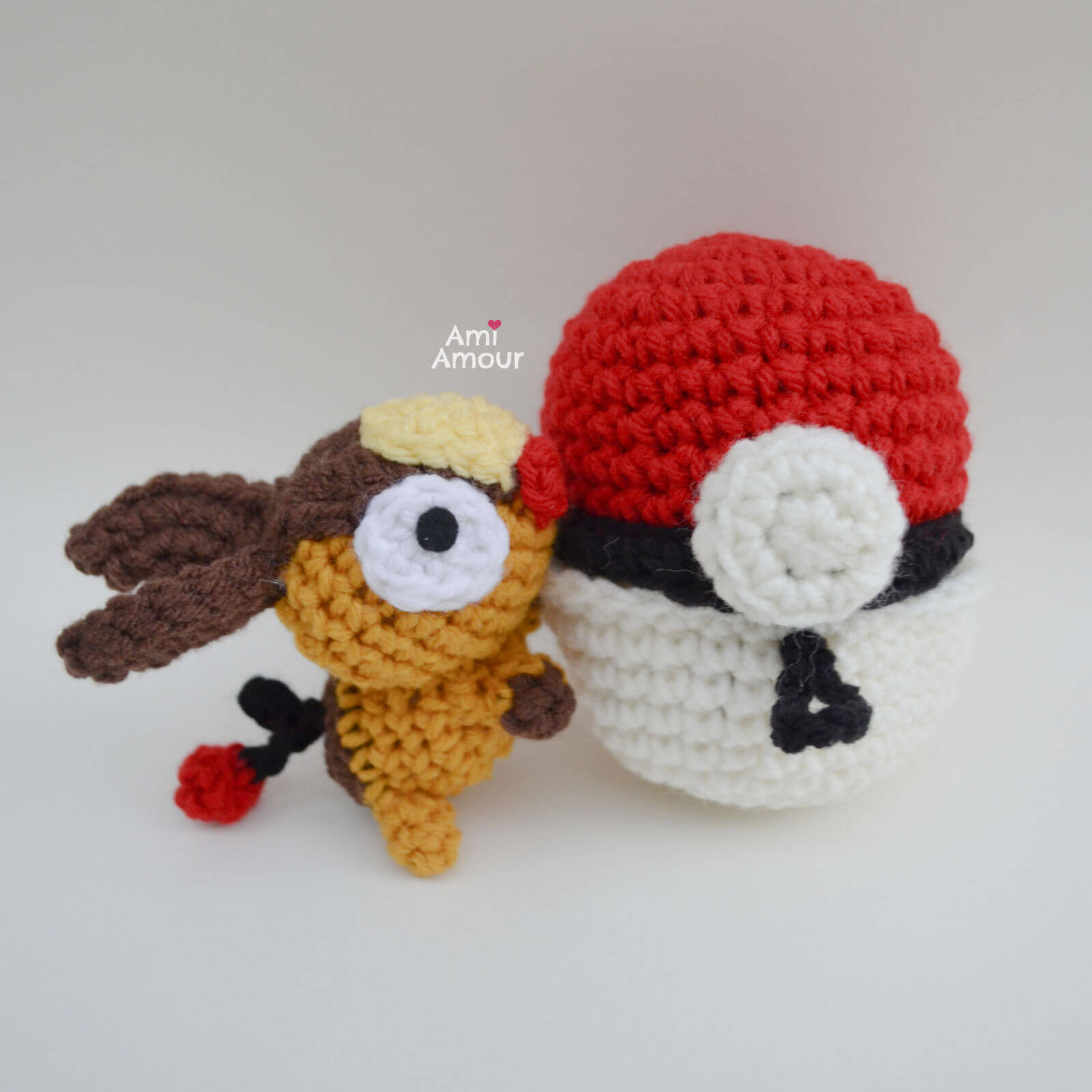Crochet Tepig hugging a Pokeall